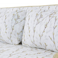 Botanical cushions and seat detail on rattan settee.