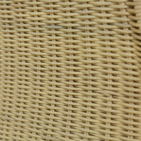 Close-up of wicker texture on rattan settee surface.