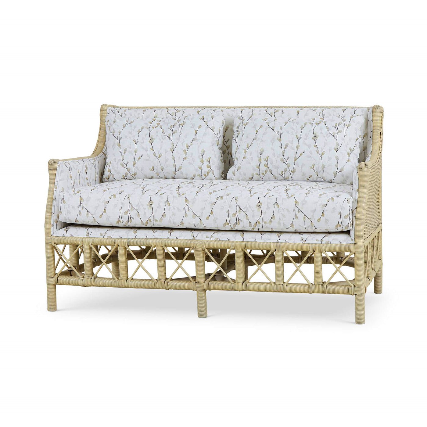 Wicker settee with botanical upholstery, three-quarter angle view.