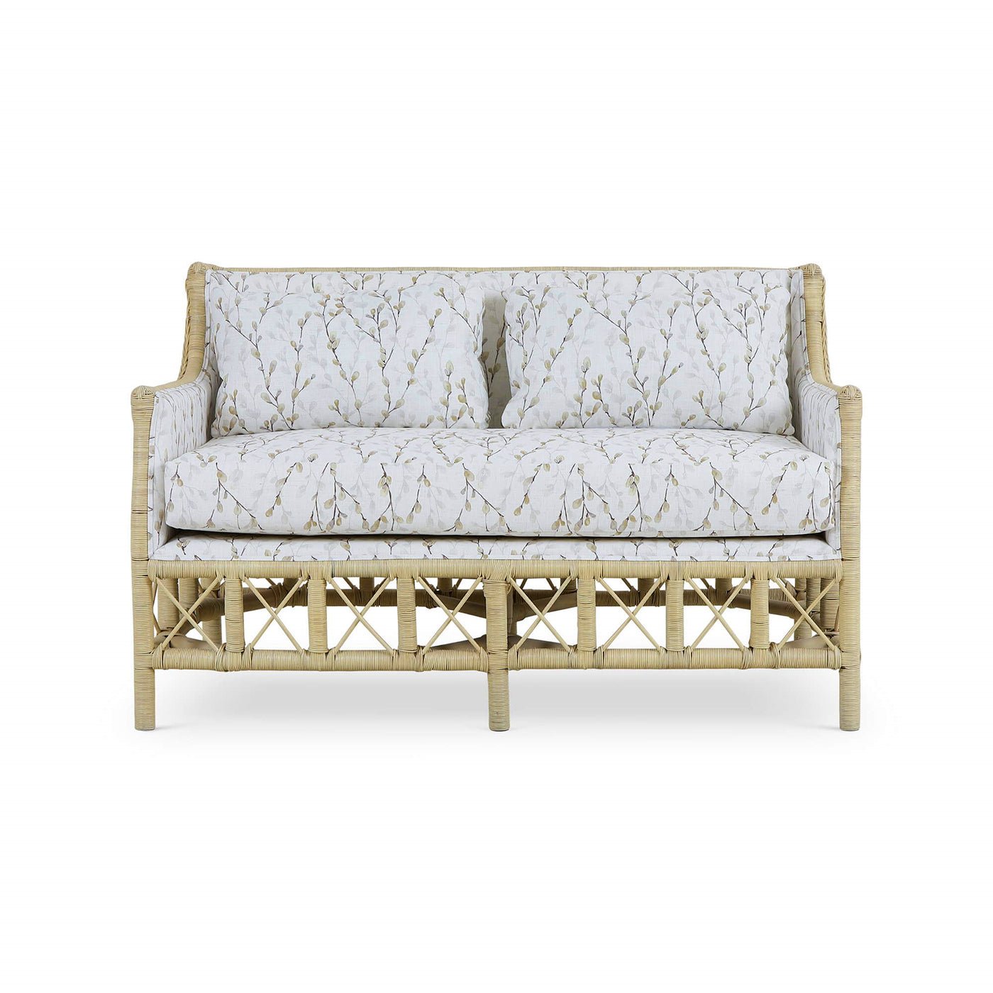 Front view of rattan settee, botanical upholstery visible.