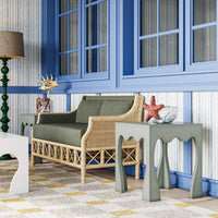 Rattan settee styled with decorative tables and accents.