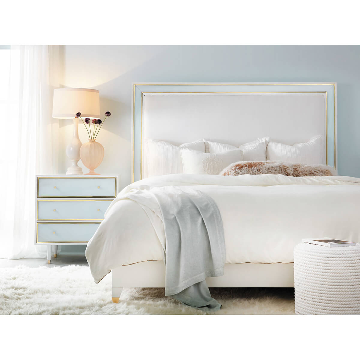 Coastal bed in styled room with nightstand.