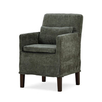 Green slipcovered dining armchair, three-quarter view.