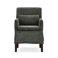 Green slipcovered dining armchair, front view with pillow.