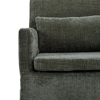 Green slipcovered dining armchair, partial front with cushion.