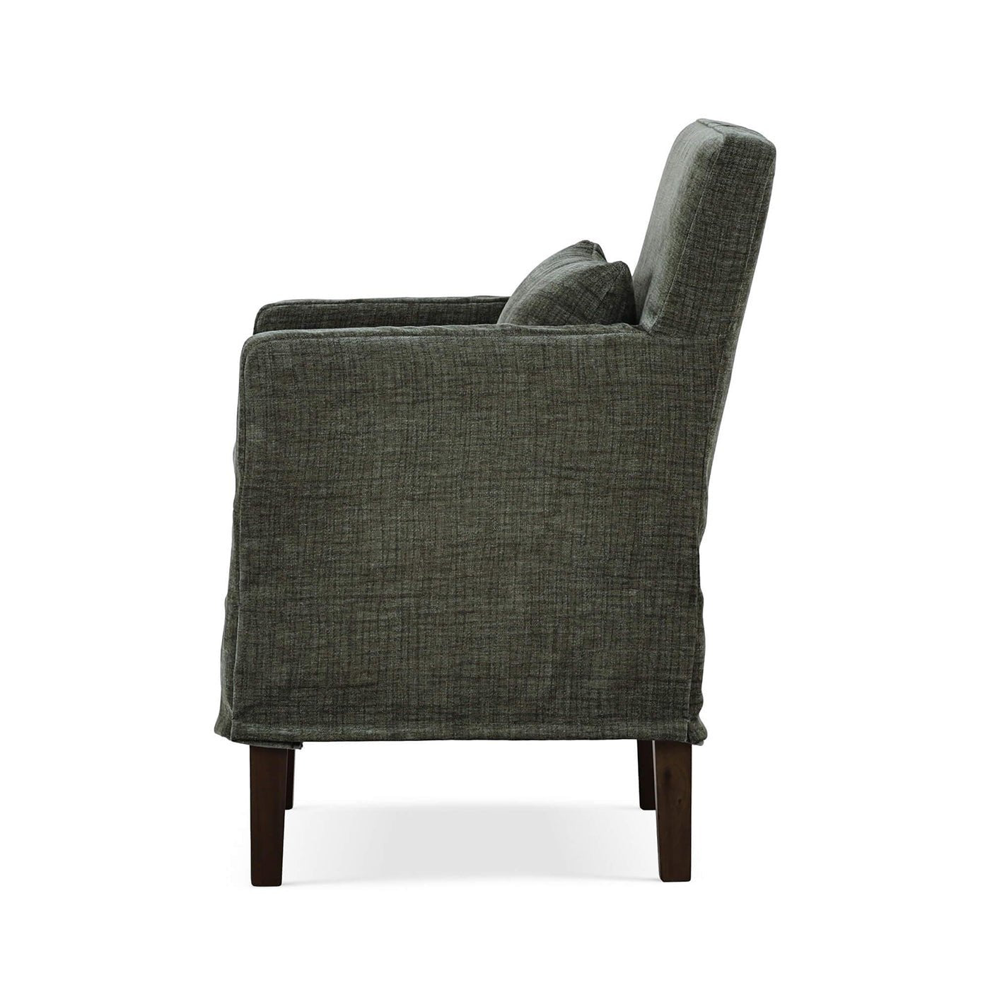 Green slipcovered dining armchair, side profile.
