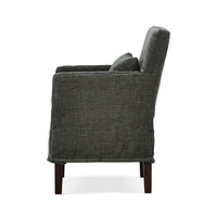 Green slipcovered dining armchair, side profile.