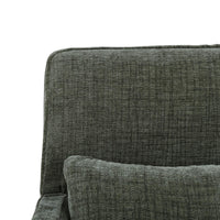 Green slipcovered armchair, close-up of back and pillow.