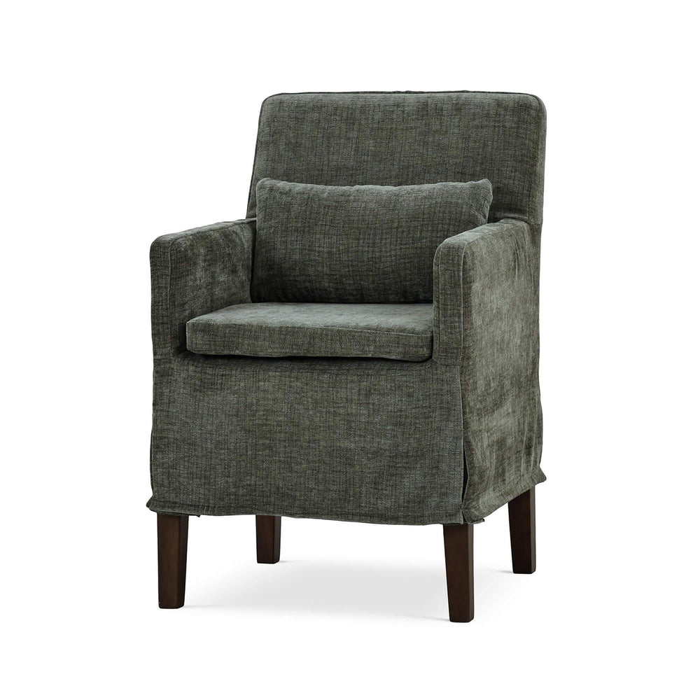 Green slipcovered dining armchair, front-angle view.