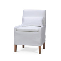 White slipcovered dining chair with pillow, front view.