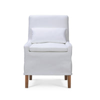 Slipcovered dining chair with cushion, front view.