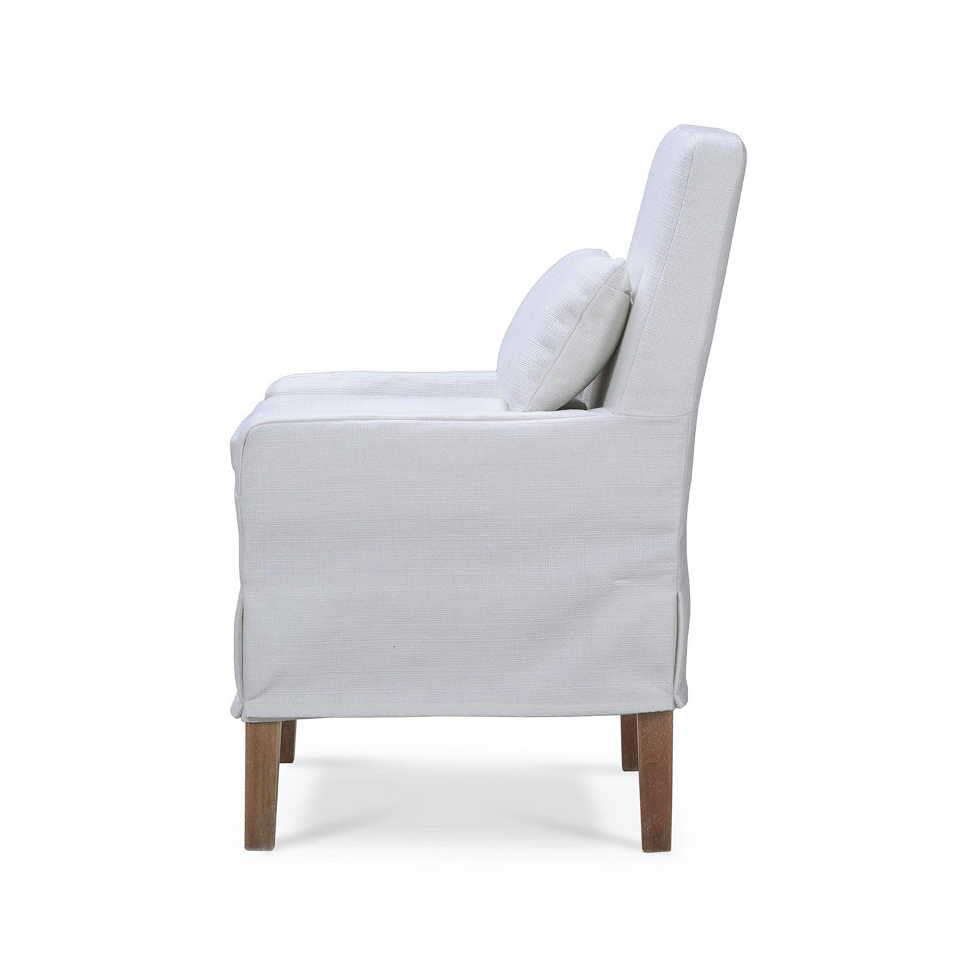 Side profile of white slipcovered dining chair.