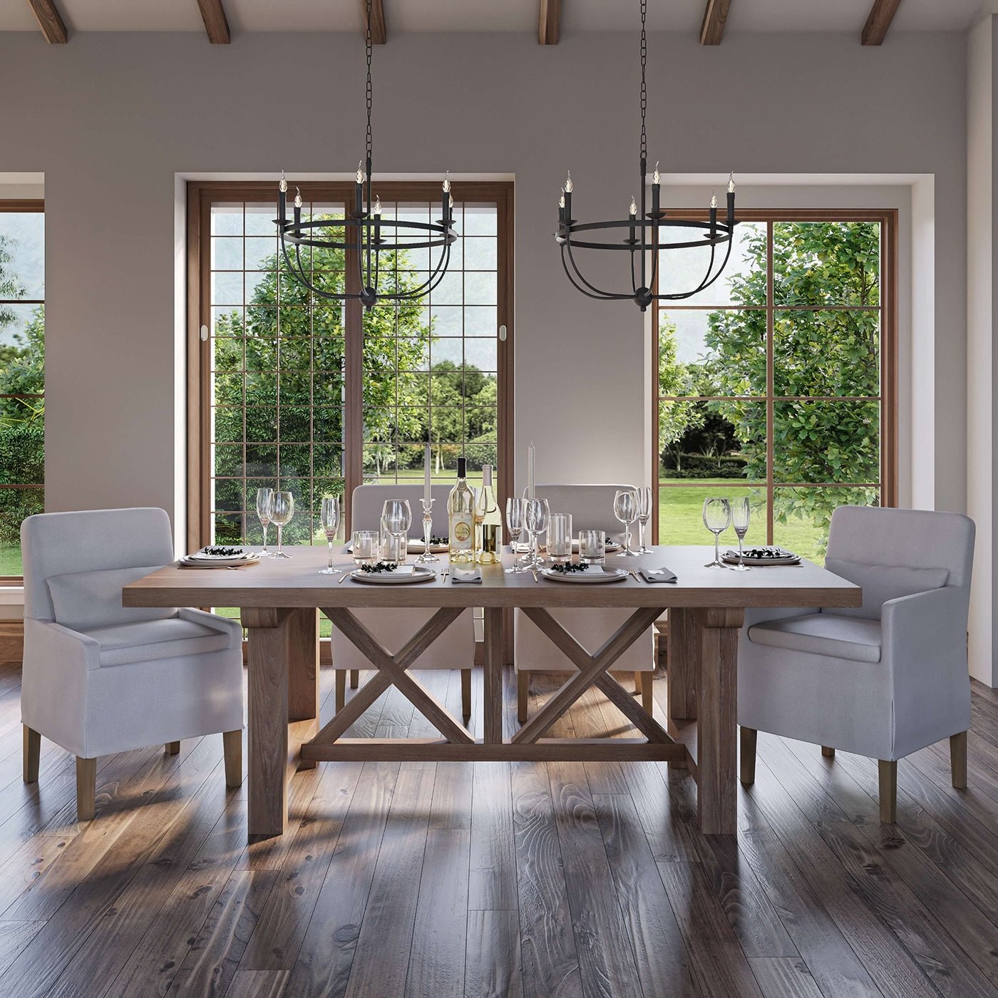 Dining room with slipcovered chairs around wooden table.