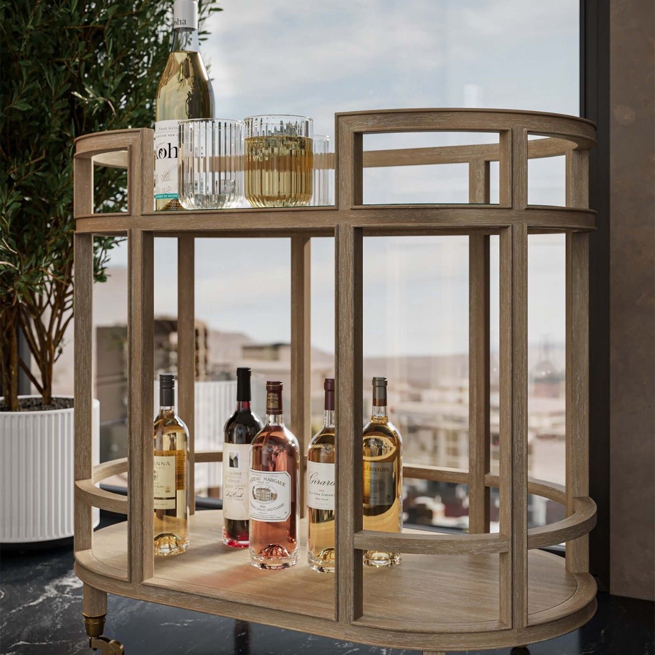 Bar cart holding wine bottles and glasses, close-up.