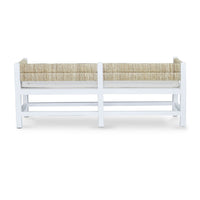 White bench with cushion, back view.