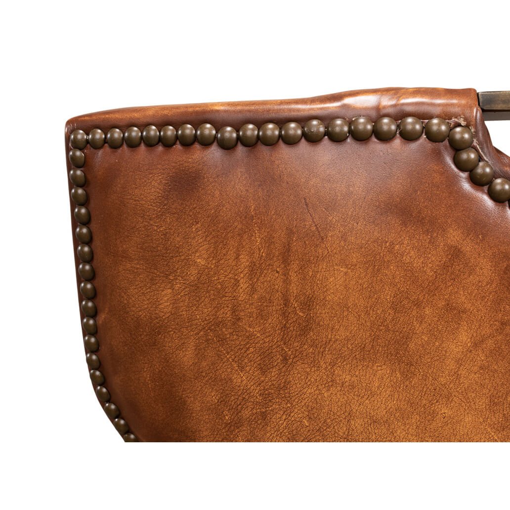 Cognac leather dining chair side nailhead trim close-up.