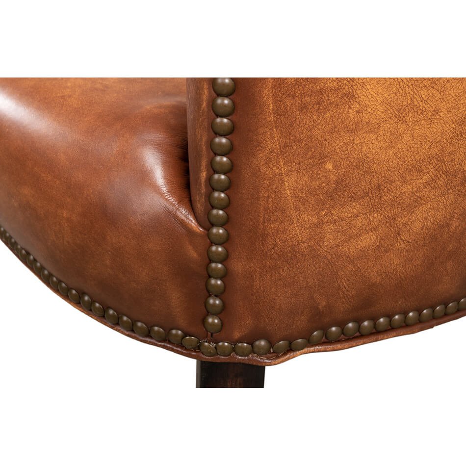 Cognac leather dining chair corner upholstery and nailhead trim.