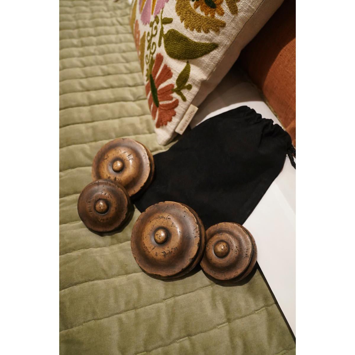 Colonial bed's decorative knob set on quilt.