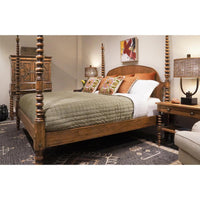 Colonial four-poster bed in cozy, decorated bedroom setting.