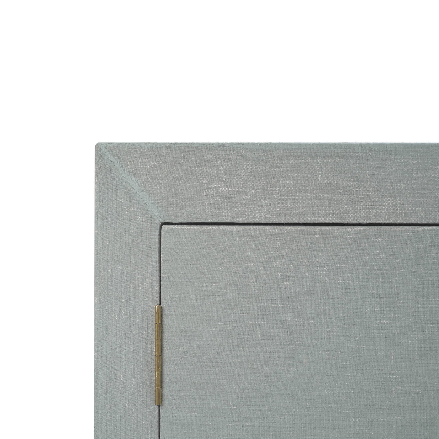 Close-up blue linen sideboard corner with visible hinge.