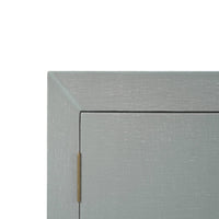 Close-up blue linen sideboard corner with visible hinge.