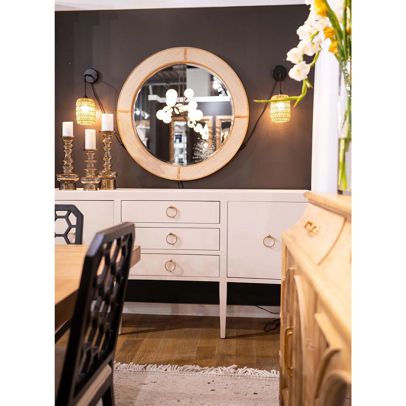 Cream linen sideboard with mirror, decorative accents and lights.