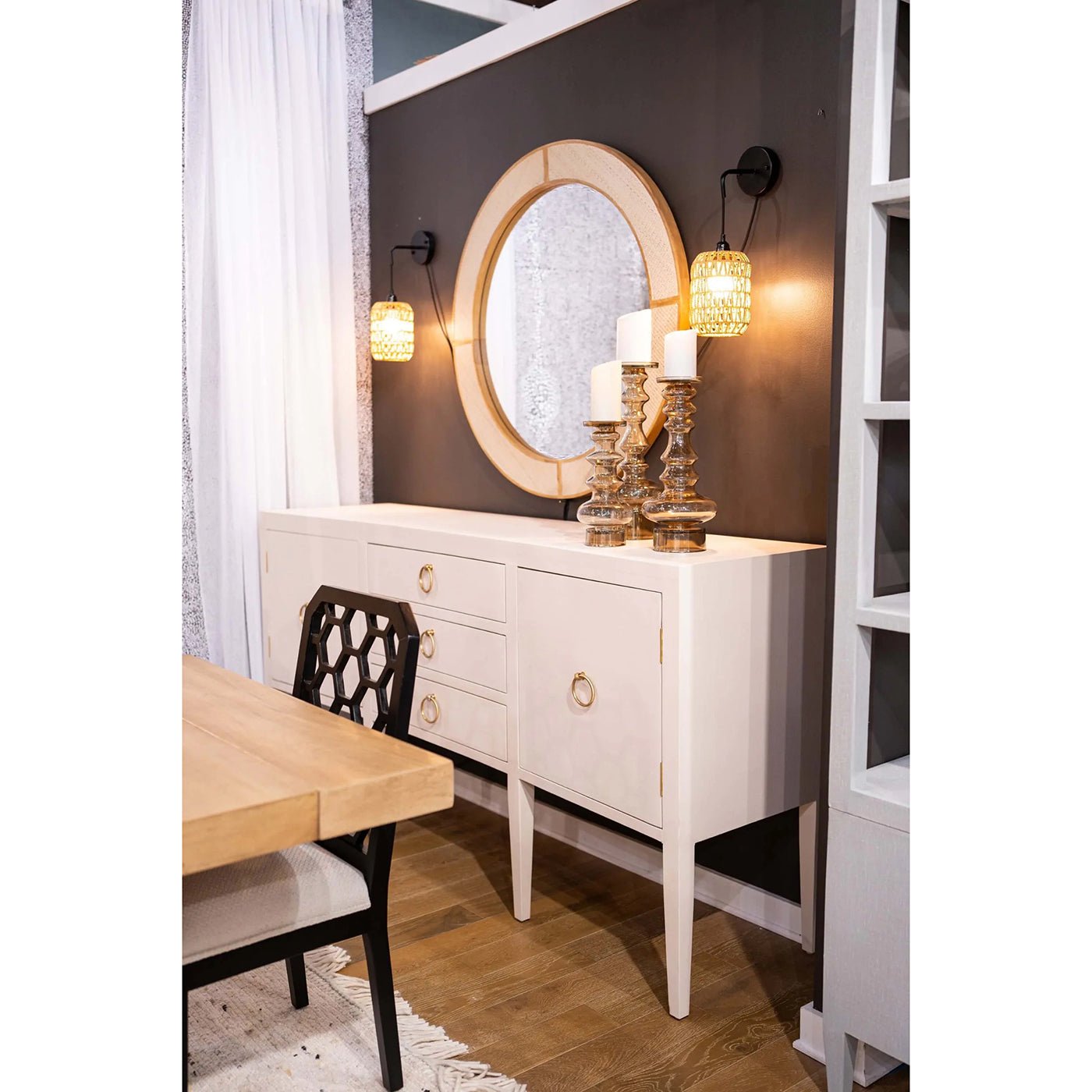 Sideboard in dining room setting, mirror and candle holders.