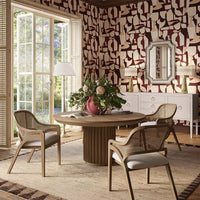 Sideboard with chairs and table, artistic wallpaper, bright interior.