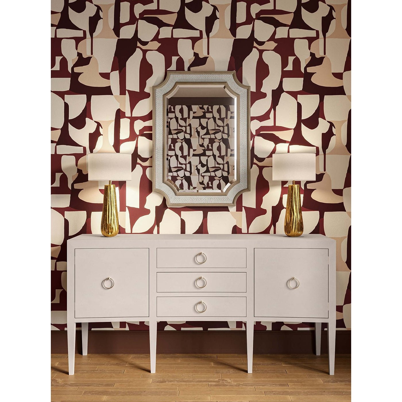 Sideboard with decorative lamps and mirror, artistic wallpaper background.