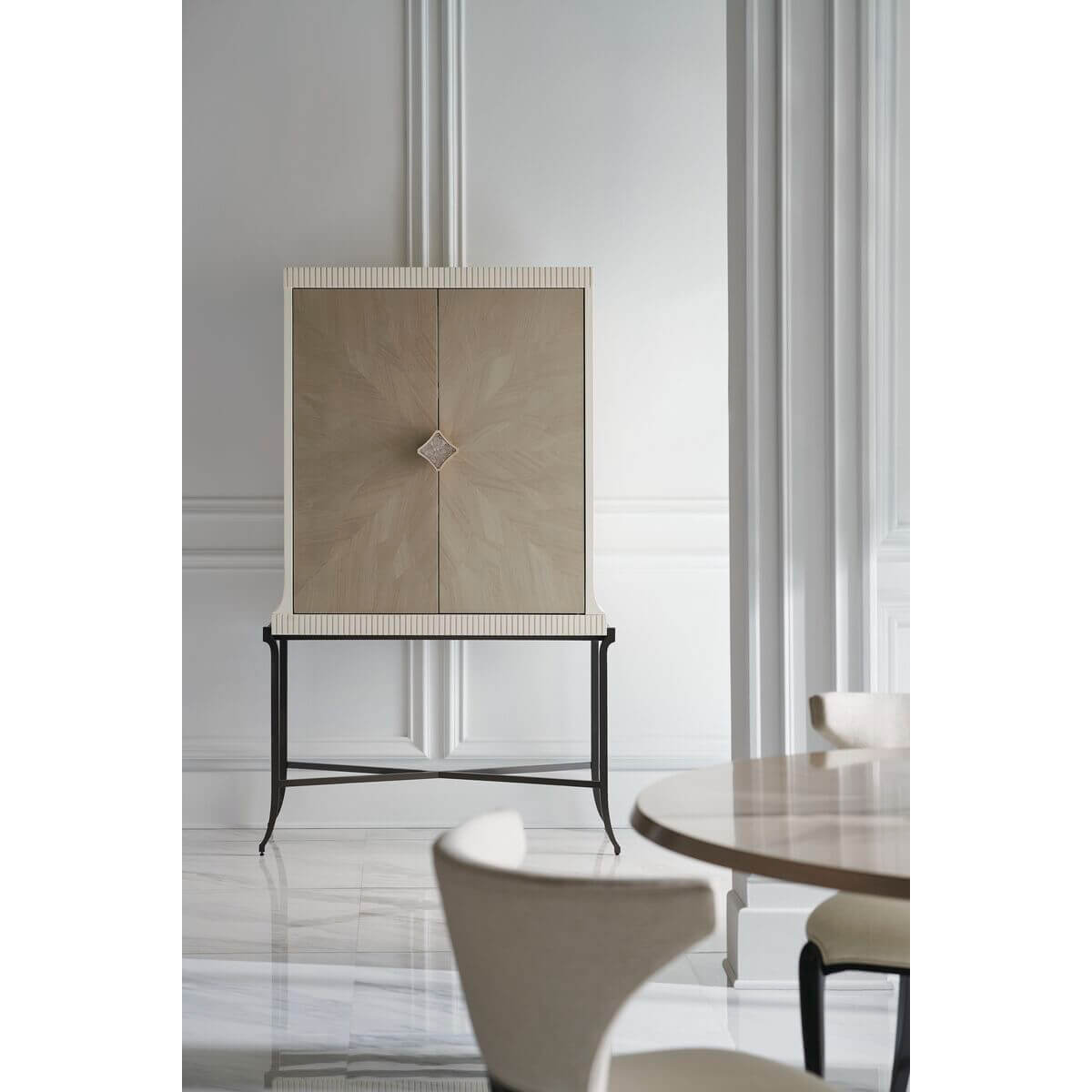 Contemporary bar cabinet against white paneled wall, side view.