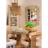 Rattan barrel dining chairs in styled room setting.