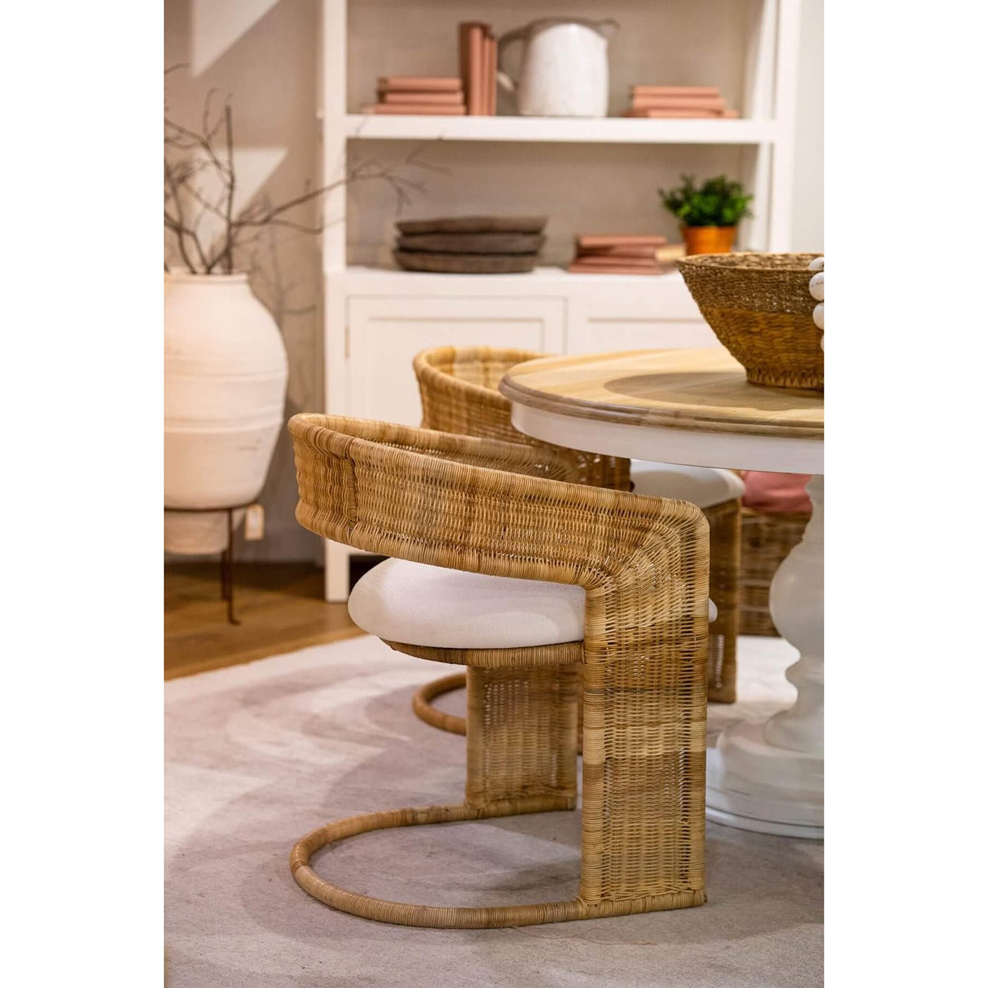 Rattan barrel dining chairs around dining table.
