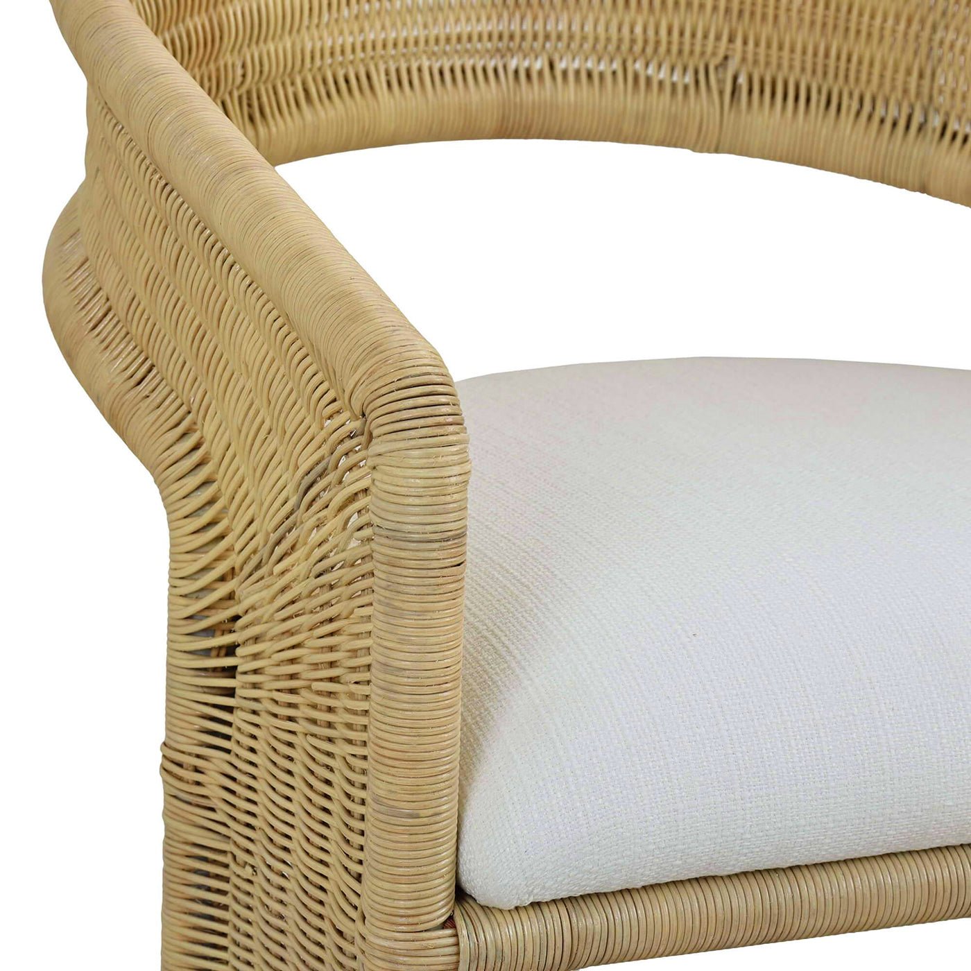 Rattan barrel dining chair armrest and cushion detail.