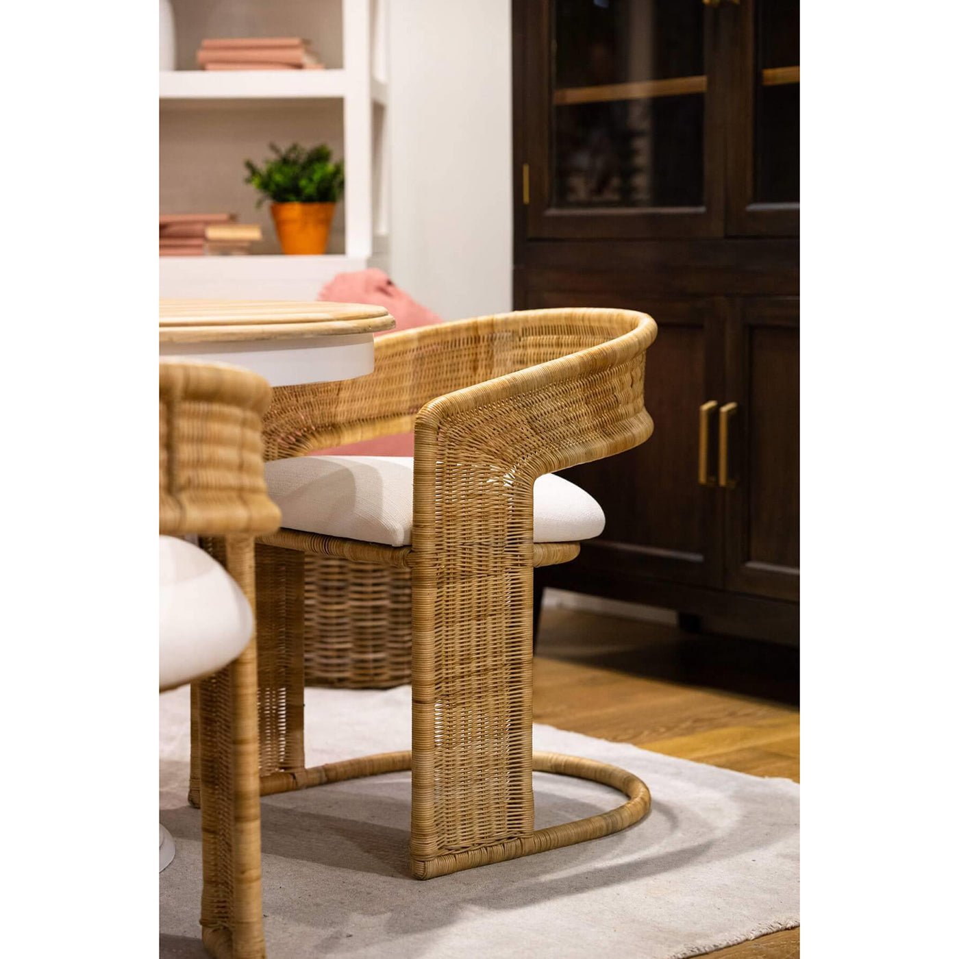 Rattan barrel dining chair in cozy dining room.