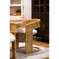 Rattan barrel dining chair in cozy dining room.