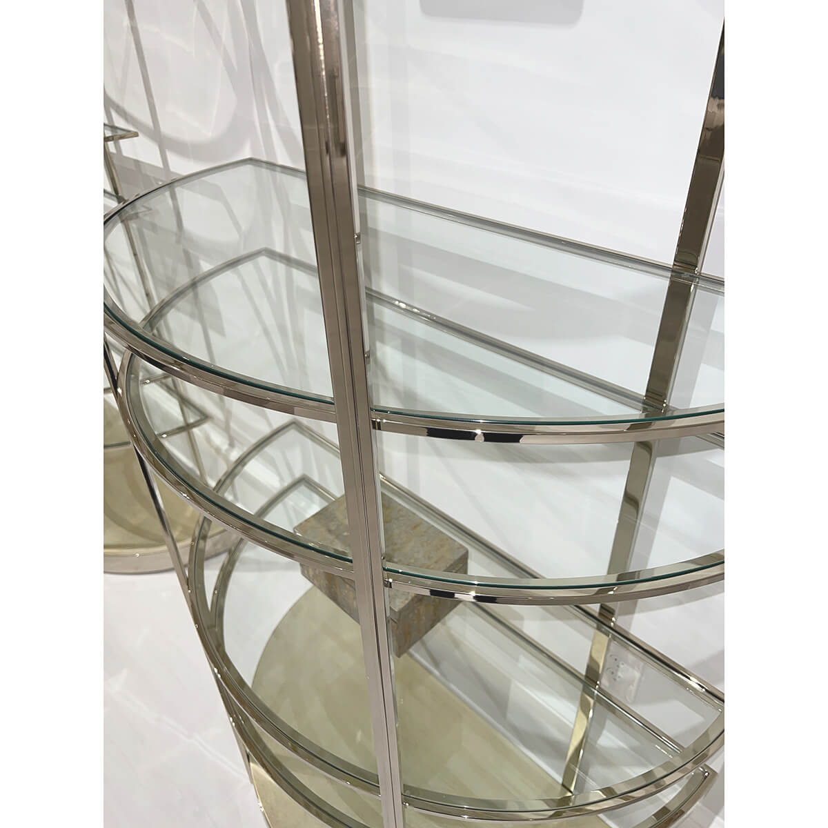Detail of glass shelves on brass etagere.