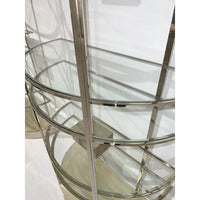 Detail of glass shelves on brass etagere.