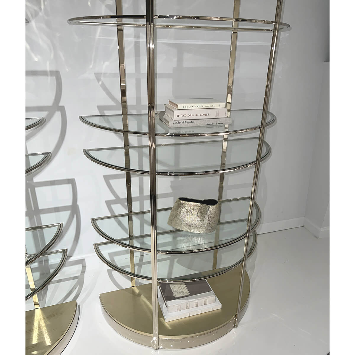 Etagere displaying books and accessories, close-up view.