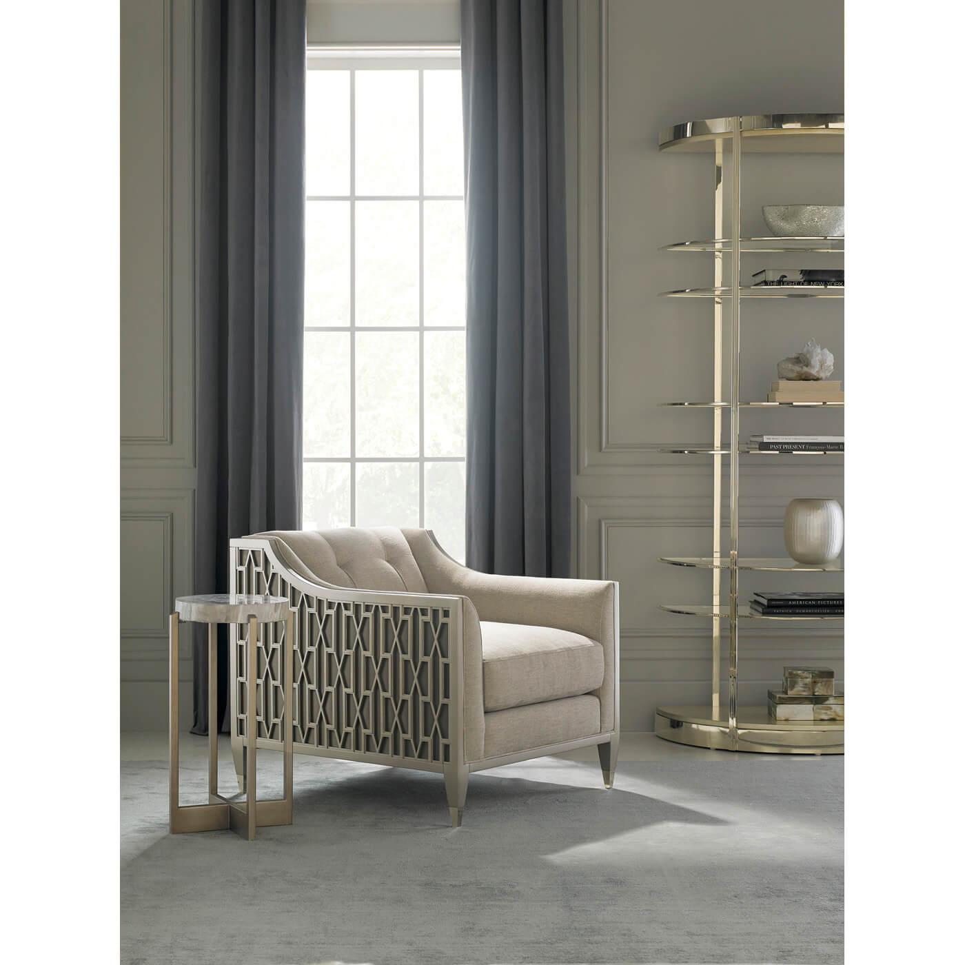 Etagere with neutral armchair and decorative items.