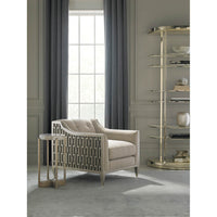 Etagere with neutral armchair and decorative items.