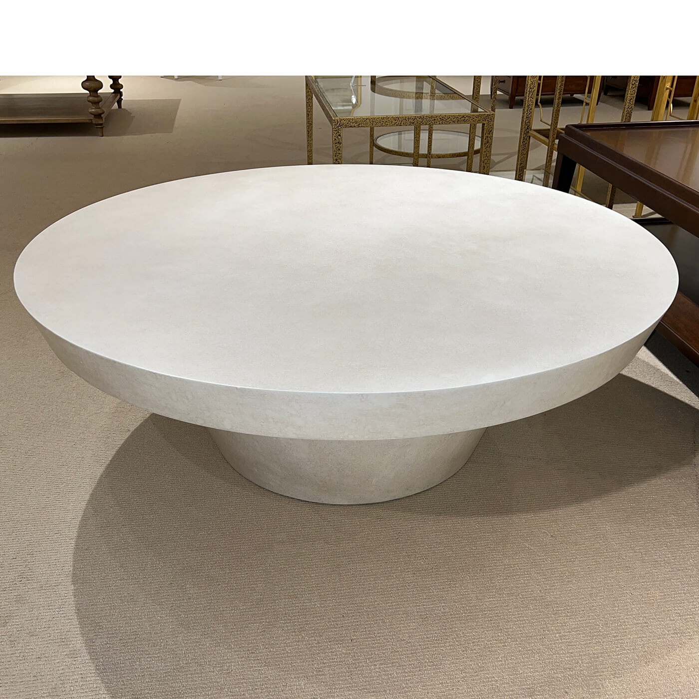Contemporary round coffee table, top view, showroom setting.