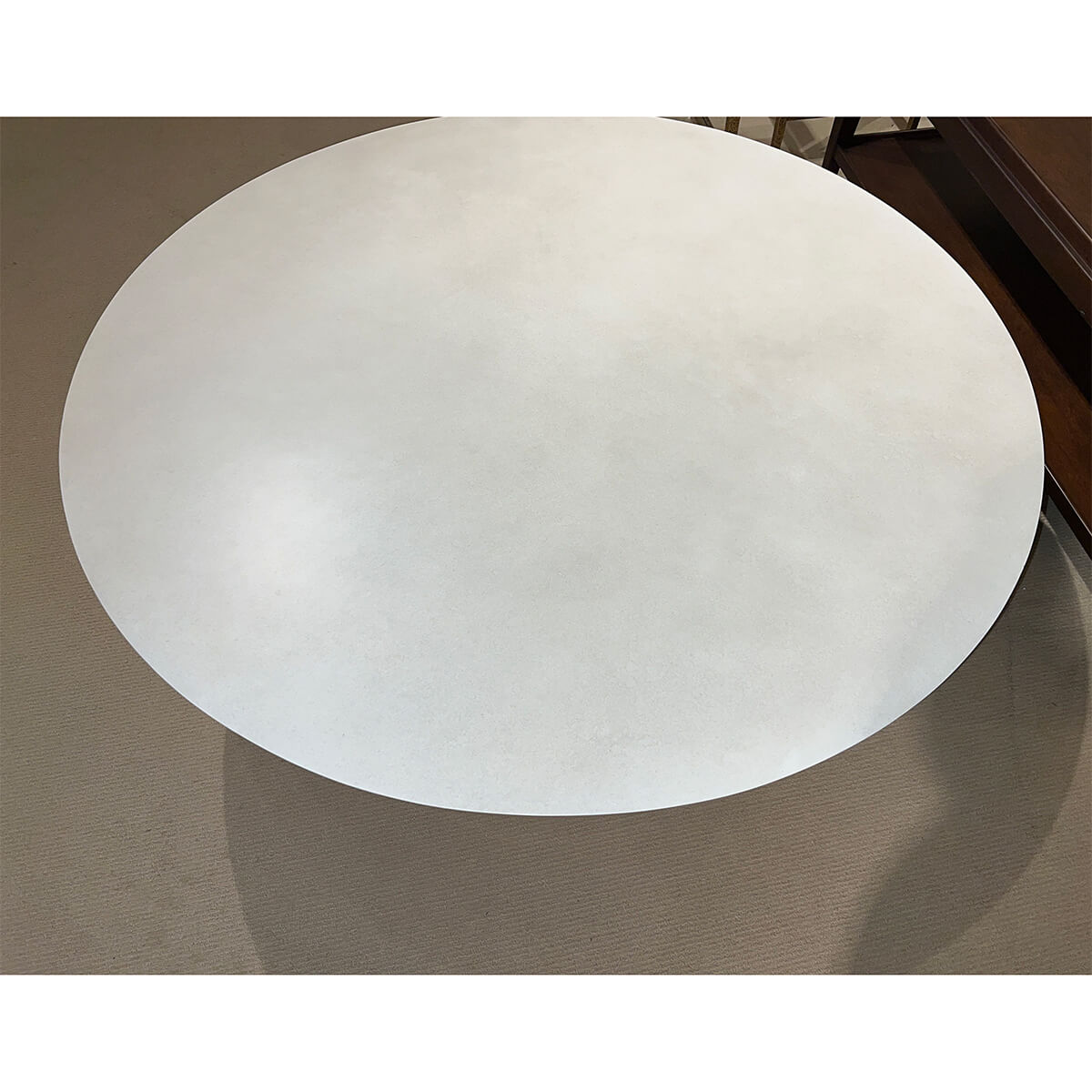 Contemporary round coffee table, close-up of tabletop surface.