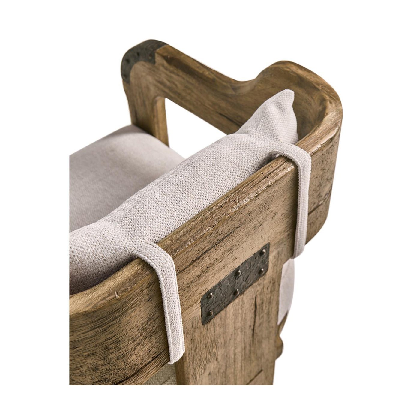Backrest detail with fabric strap on wooden chair.