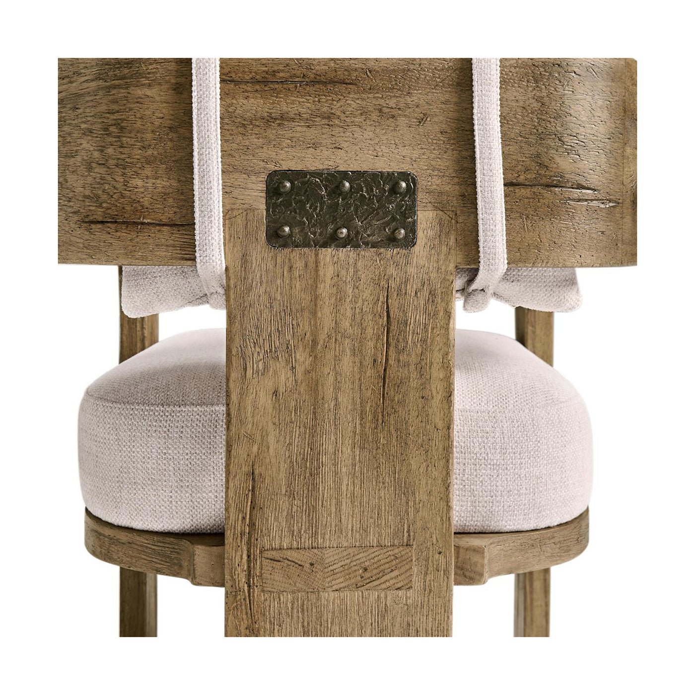 Close-up of wooden armchair back with metal detail.