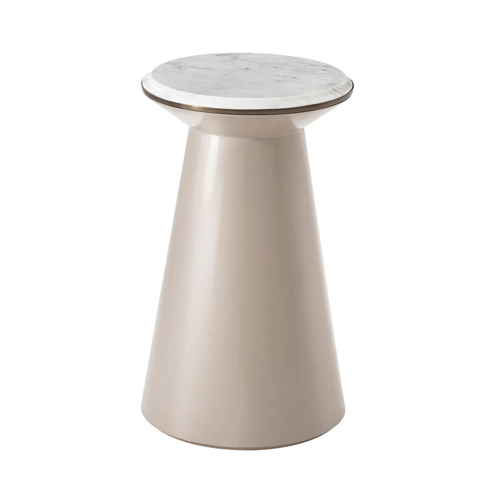 Tan accent table with marble top, side view.