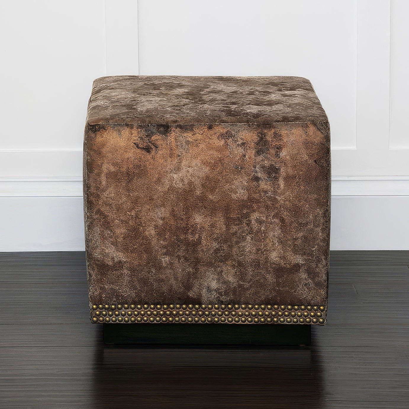 Straight view of copper velvet ottoman against white background.