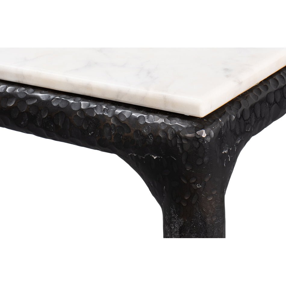 Close-up of dining table leg, hammered texture visible.