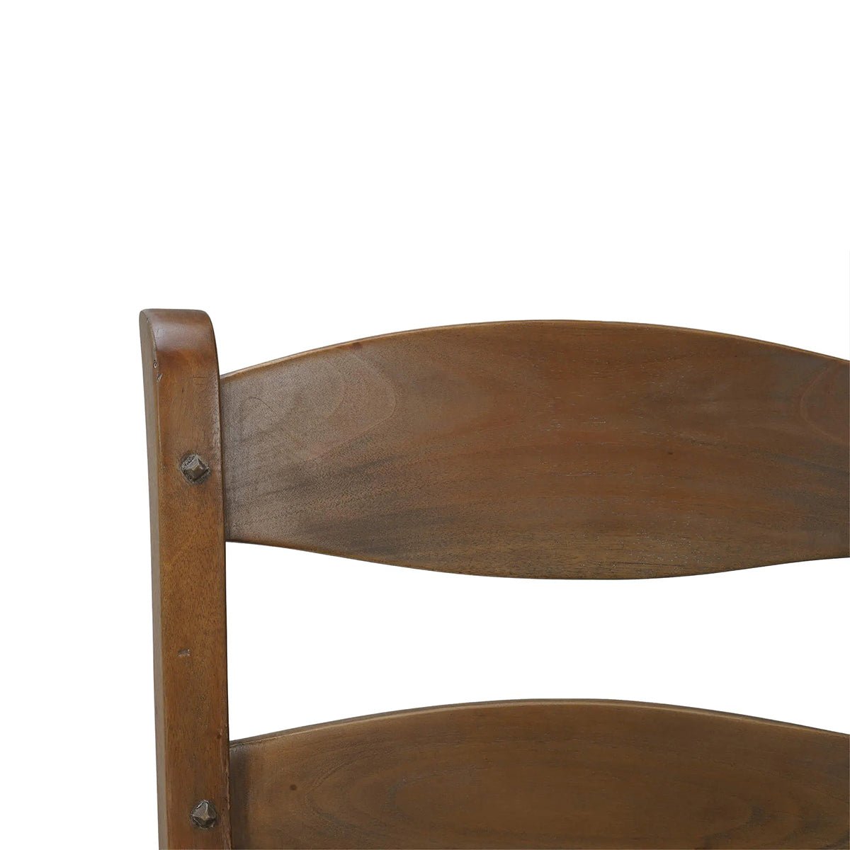 Close-up of wooden ladder back chair's top slat.