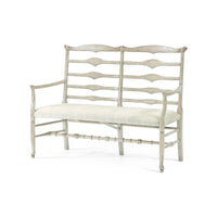 Whitewashed wooden bench with ladder back and cushion.