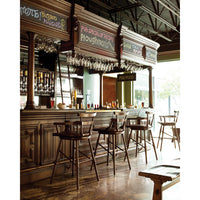 Bar interior with rustic bar stools at counter.